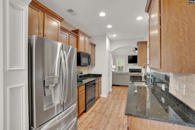 330 Lanyard Ln, Chapin, SC 29036 - kitchen with black appliances, open floor plan, backsplash, light wood-style flooring, and arched walkways
