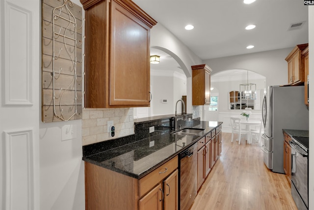 330 Lanyard Ln, Chapin, SC 29036 - kitchen featuring dishwashing machine, arched walkways, range, light wood-type flooring, and dark stone counters