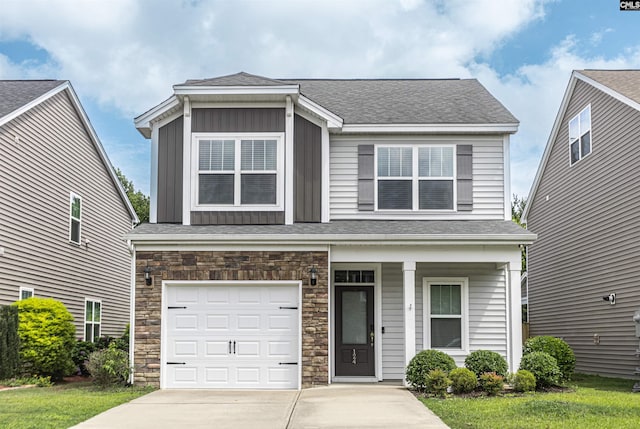 124 Weeping Oak Ln, West Columbia, SC 29169 - view of front of house with concrete driveway, stone siding, covered porch, an attached garage, and board and batten siding