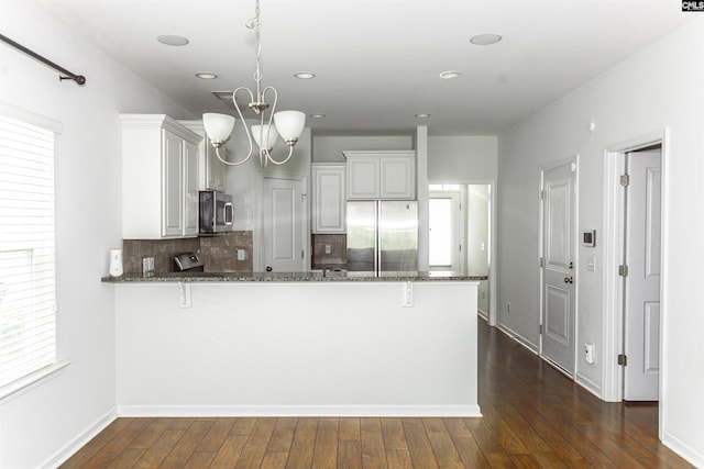 124 Weeping Oak Ln, West Columbia, SC 29169 - kitchen featuring appliances with stainless steel finishes, dark stone countertops, recessed lighting, a peninsula, and decorative backsplash