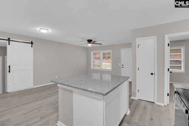 112 Woodcrest Dr, Columbia, SC 29203 - kitchen with light wood finished floors, a barn door, ceiling fan, a center island, and electric range