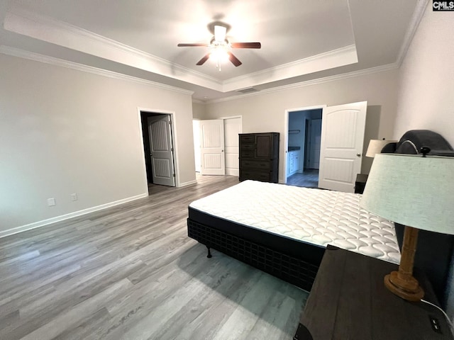124 Doolittle Dr, Chapin, SC 29036 - bedroom with a tray ceiling, light wood finished floors, ornamental molding, ensuite bathroom, and ceiling fan