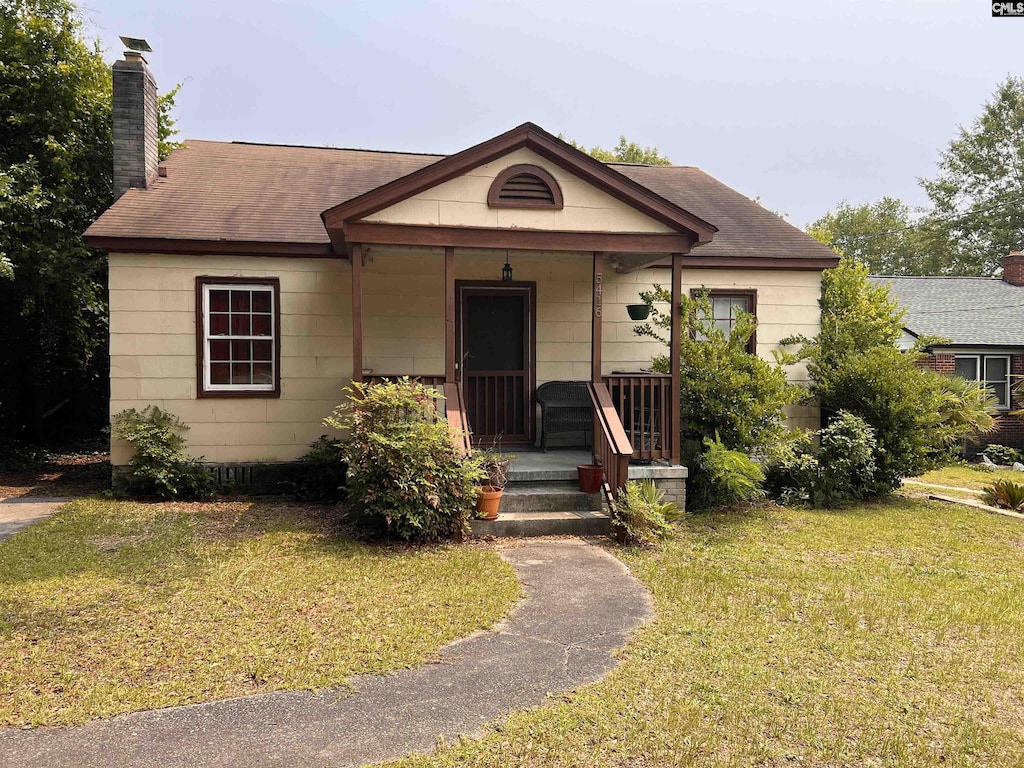5416 Fairfield Rd, Columbia, SC 29203 - view of front of property featuring a chimney, a porch, a front yard, and a shingled roof