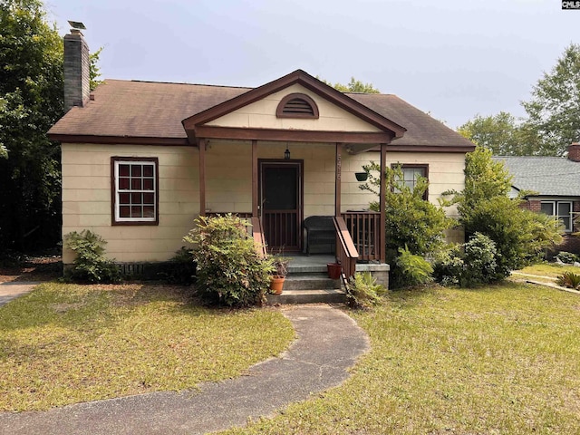 5416 Fairfield Rd, Columbia, SC 29203 - view of front of property featuring a chimney, a porch, a front yard, and a shingled roof