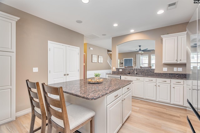 634 Bluff Pointe, Columbia, SC 29212 - kitchen with a ceiling fan, a center island, white cabinets, a kitchen breakfast bar, and recessed lighting