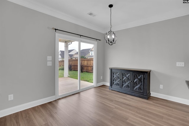 935 Taramore Ln, Lexington, SC 29072 - unfurnished dining area with wood finished floors, a chandelier, and ornamental molding