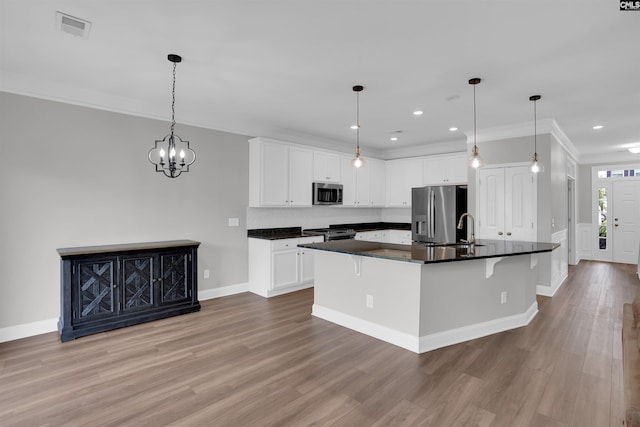 935 Taramore Ln, Lexington, SC 29072 - kitchen with appliances with stainless steel finishes, dark countertops, light wood-style flooring, a kitchen bar, and white cabinetry