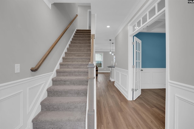 935 Taramore Ln, Lexington, SC 29072 - stairway featuring wood finished floors, a decorative wall, a wainscoted wall, recessed lighting, and crown molding