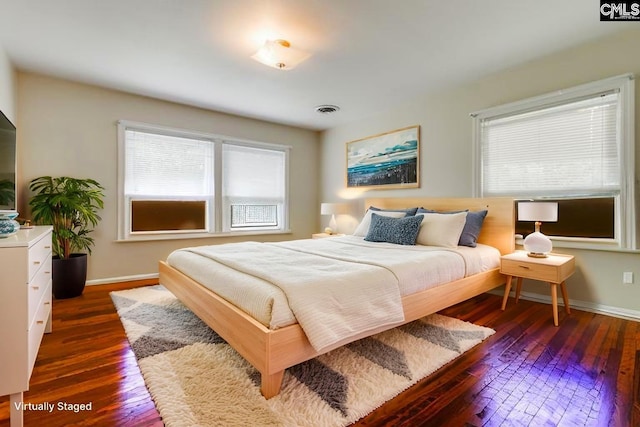 6413 Bridgewood Rd, Columbia, SC 29206 - bedroom with multiple windows and dark wood-style floors