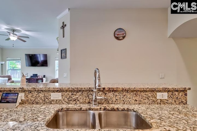 1817 Crystal Ln, West Columbia, SC 29170 - kitchen featuring ceiling fan, light stone counters, open floor plan, and ornamental molding
