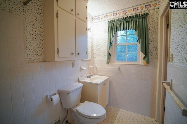 114 Robinson, North, SC 29112 - bathroom with vanity, tile walls, wallpapered walls, and wainscoting