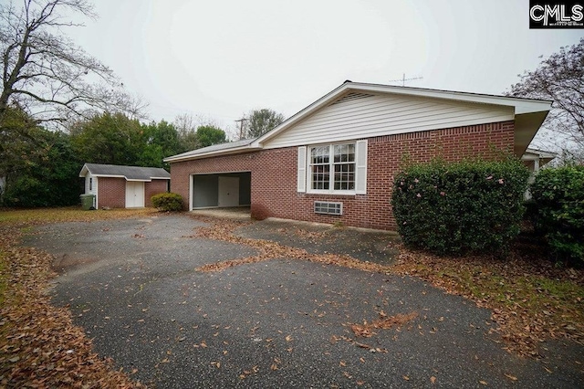 114 Robinson, North, SC 29112 - view of property exterior with brick siding, a storage shed, asphalt driveway, and an attached carport