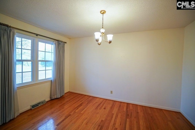 114 Robinson, North, SC 29112 - empty room featuring light wood finished floors and a chandelier