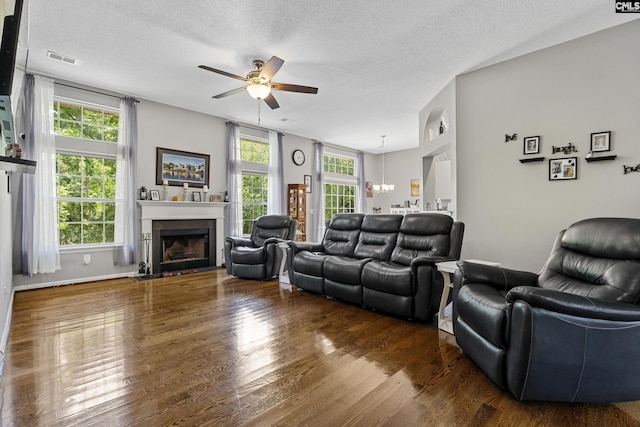 115 Black Creek Ln, Irmo, SC 29063 - living room with ceiling fan, a textured ceiling, wood finished floors, a fireplace with flush hearth, and a chandelier