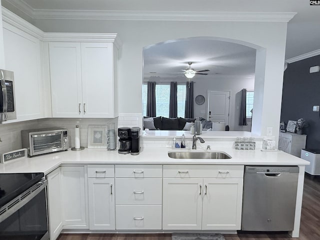 122 Tannery Way, Lexington, SC 29073 - kitchen featuring appliances with stainless steel finishes, arched walkways, ceiling fan, white cabinets, and crown molding