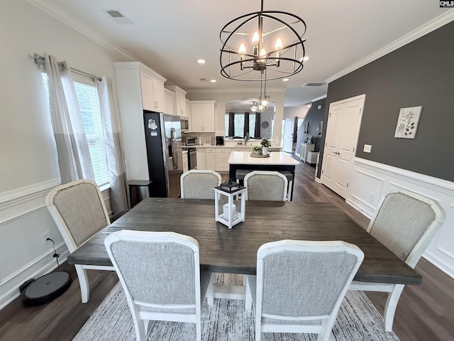 122 Tannery Way, Lexington, SC 29073 - dining room featuring a chandelier, dark wood-style floors, a decorative wall, wainscoting, and ornamental molding