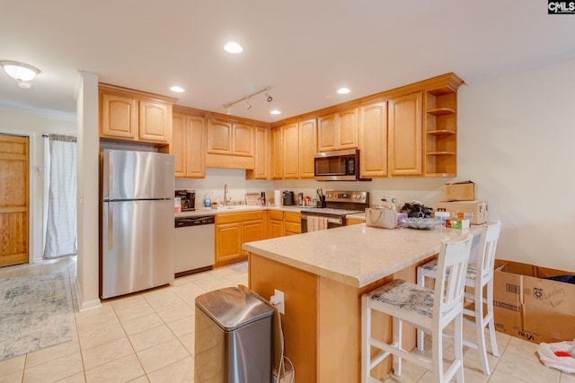 301 Harbor Heights Dr Unit 17D, Lexington, SC 29072 - kitchen featuring stainless steel appliances, a peninsula, ornamental molding, light brown cabinetry, and light countertops