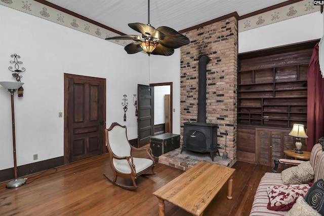 1208 Peacehaven Rd, Chapin, SC 29036 - living area featuring wood finished floors, a wood stove, ceiling fan, and ornamental molding