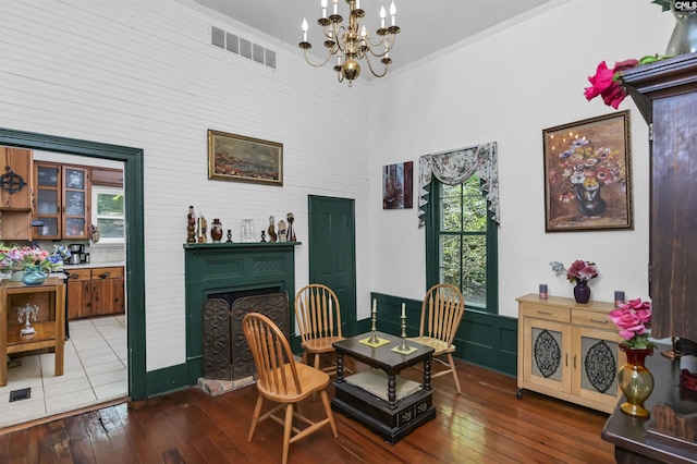 1208 Peacehaven Rd, Chapin, SC 29036 - sitting room featuring a chandelier, hardwood / wood-style floors, healthy amount of natural light, a fireplace with raised hearth, and crown molding