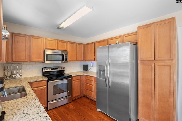 140 Springhaven Dr, Columbia, SC 29210 - kitchen with stainless steel appliances, dark wood-type flooring, backsplash, and light stone countertops