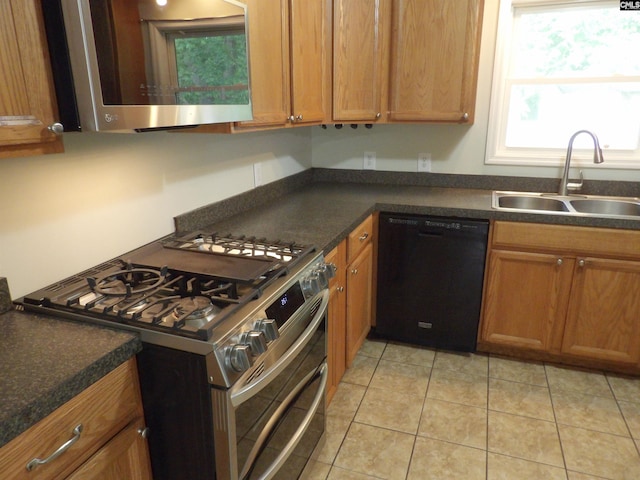 1016 Willis St, Batesburg, SC 29006 - kitchen with appliances with stainless steel finishes, dark countertops, healthy amount of natural light, and brown cabinetry