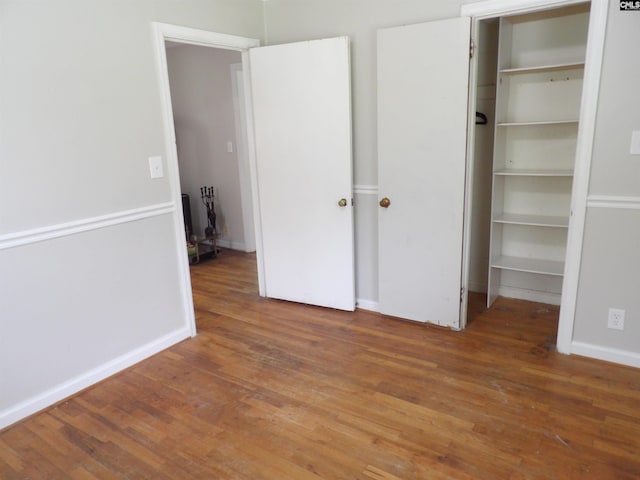 1016 Willis St, Batesburg, SC 29006 - unfurnished bedroom featuring wood finished floors, a walk in closet, and a closet