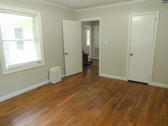 1016 Willis St, Batesburg, SC 29006 - unfurnished bedroom with ornamental molding, multiple windows, and wood finished floors
