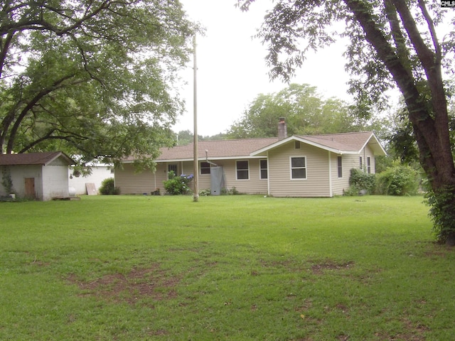 1016 Willis St, Batesburg, SC 29006 - rear view of house featuring a lawn, a chimney, and a storage shed