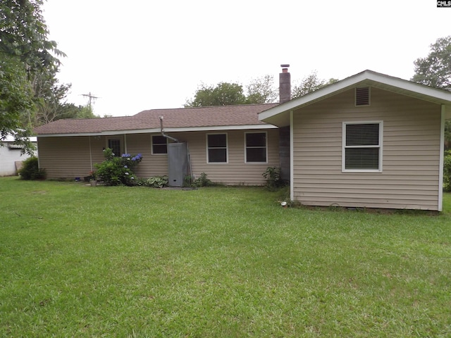 1016 Willis St, Batesburg, SC 29006 - back of house featuring a lawn, a chimney, and roof with shingles