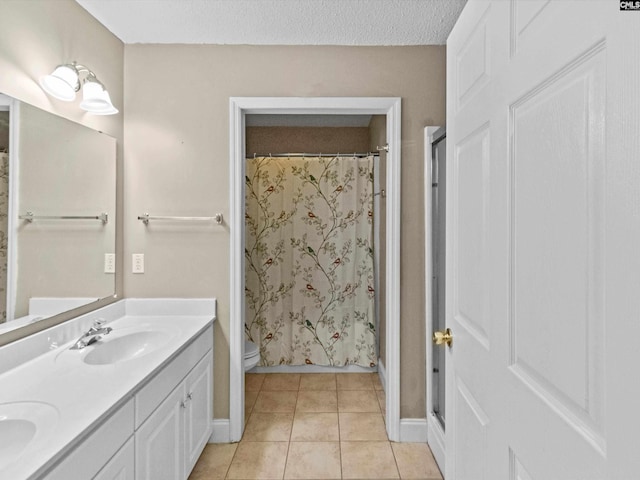 302 Brown St, Prosperity, SC 29127 - bathroom featuring double vanity, tile patterned flooring, curtained shower, and a textured ceiling