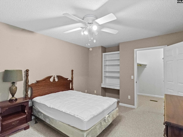 302 Brown St, Prosperity, SC 29127 - bedroom with carpet flooring, a textured ceiling, a walk in closet, and a ceiling fan