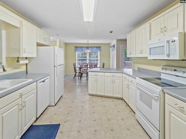 302 Brown St, Prosperity, SC 29127 - kitchen with white appliances, a peninsula, and white cabinetry