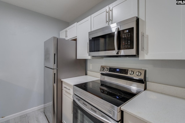1320 Piney Grove Rd Unit 3C, Columbia, SC 29210 - kitchen with appliances with stainless steel finishes, white cabinets, and light countertops