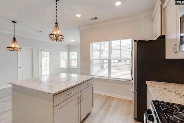 508 Esaw Dr, Elgin, SC 29045 - kitchen with range with gas cooktop, decorative light fixtures, ornamental molding, light stone counters, and a center island