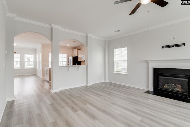 508 Esaw Dr, Elgin, SC 29045 - unfurnished living room featuring crown molding, light wood-style flooring, ceiling fan, and a glass covered fireplace