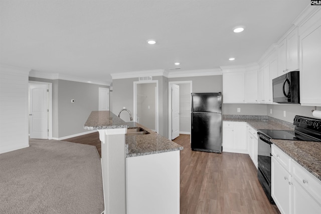 239 Common Reed Dr, Gilbert, SC 29054 - kitchen featuring black appliances, ornamental molding, recessed lighting, a center island with sink, and white cabinetry