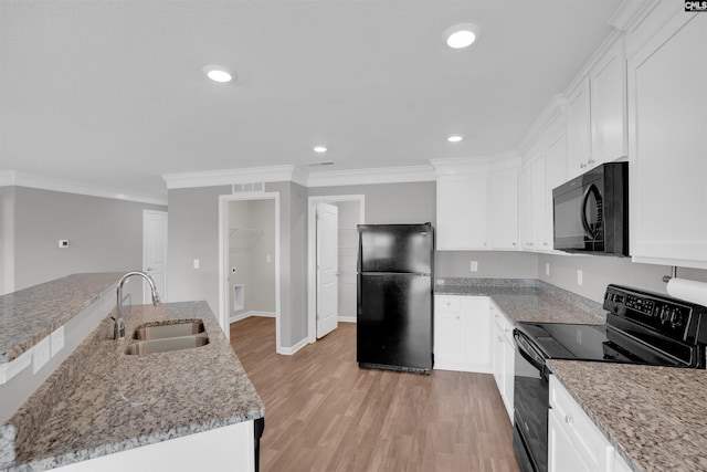 239 Common Reed Dr, Gilbert, SC 29054 - kitchen with black appliances, ornamental molding, light wood finished floors, white cabinets, and recessed lighting
