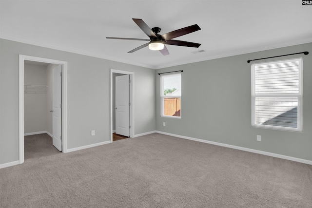 239 Common Reed Dr, Gilbert, SC 29054 - unfurnished bedroom with crown molding, a walk in closet, carpet floors, ceiling fan, and a closet