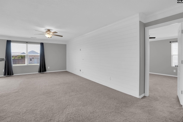 239 Common Reed Dr, Gilbert, SC 29054 - unfurnished room with crown molding, a ceiling fan, carpet, healthy amount of natural light, and wood walls