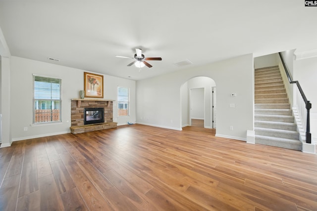 129 River Bridge Ln, Lexington, SC 29073 - unfurnished living room featuring ceiling fan, arched walkways, healthy amount of natural light, and light wood-style floors