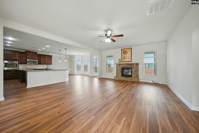 129 River Bridge Ln, Lexington, SC 29073 - unfurnished living room with a ceiling fan, wood finished floors, and a fireplace