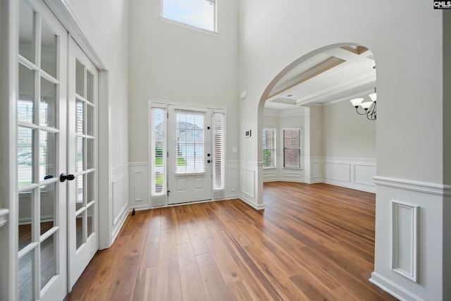 129 River Bridge Ln, Lexington, SC 29073 - entryway featuring arched walkways, a chandelier, french doors, a wainscoted wall, and a towering ceiling