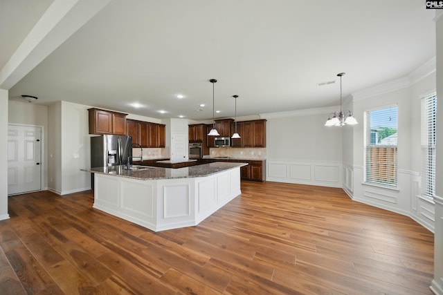 129 River Bridge Ln, Lexington, SC 29073 - kitchen with stainless steel appliances, a chandelier, a large island with sink, wood finished floors, and ornamental molding