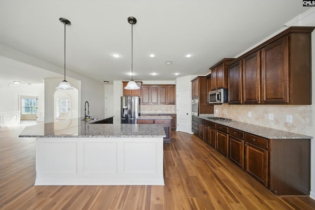 129 River Bridge Ln, Lexington, SC 29073 - kitchen featuring appliances with stainless steel finishes, a spacious island, light wood-type flooring, decorative backsplash, and recessed lighting