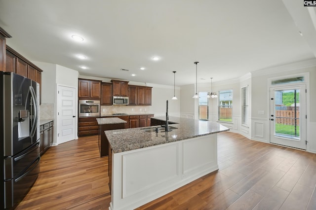 129 River Bridge Ln, Lexington, SC 29073 - kitchen with appliances with stainless steel finishes, a spacious island, wood finished floors, crown molding, and backsplash
