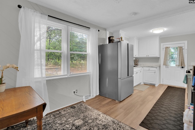 1715 Lacy St, Columbia, SC 29169 - kitchen featuring freestanding refrigerator, light wood-style floors, white cabinetry, and light countertops