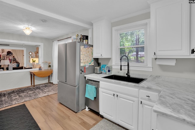 1715 Lacy St, Columbia, SC 29169 - kitchen with stainless steel appliances, light wood finished floors, white cabinetry, light countertops, and crown molding