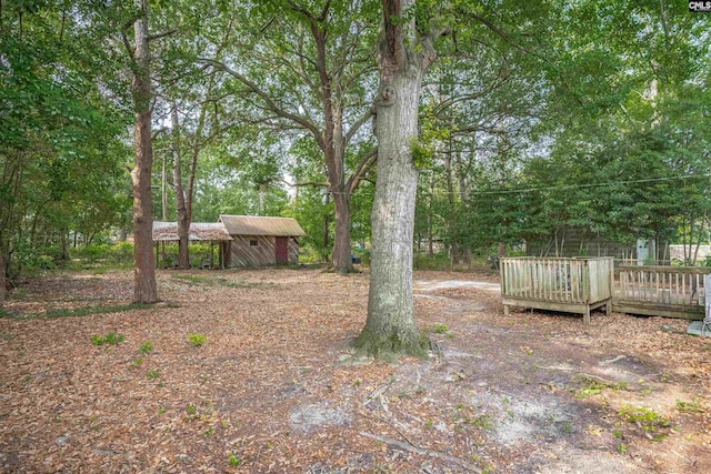 1715 Lacy St, Columbia, SC 29169 - view of yard with a wooden deck, a shed, and view of scattered trees