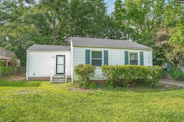 1715 Lacy St, Columbia, SC 29169 - view of front of home featuring entry steps, a front yard, a chimney, and a shingled roof