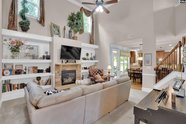 699 Village Market Dr, Chapin, SC 29036 - living room with ceiling fan, stairs, a towering ceiling, a fireplace, and carpet floors